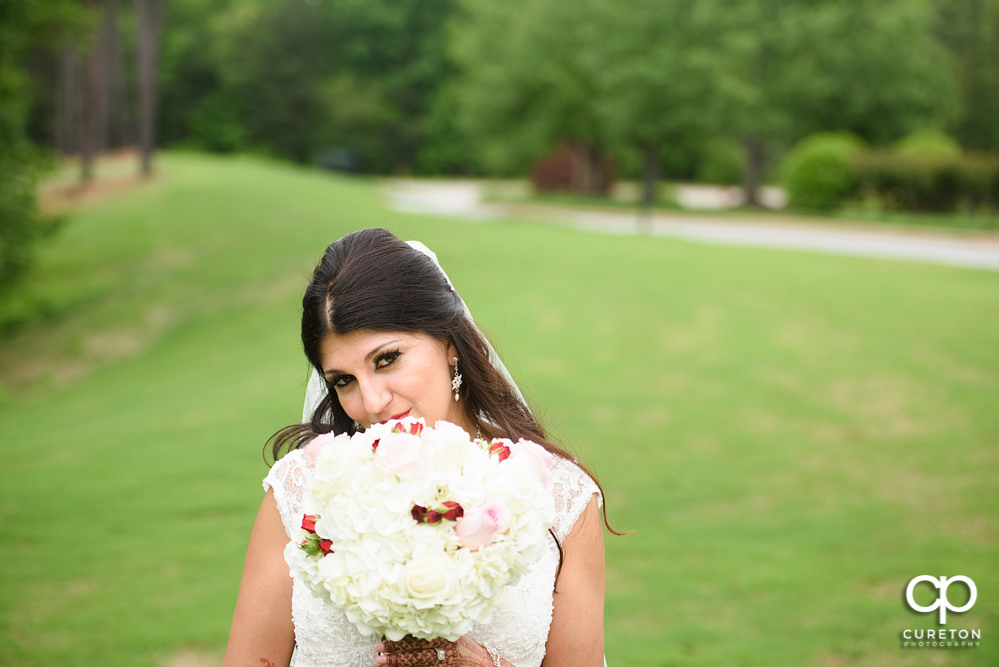 Bride and groom on the golf course at Embassy Suites.
