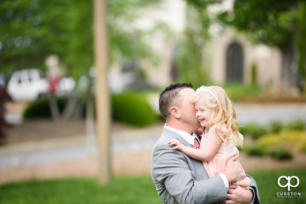 Grooms daughter joins the bride and groom before the wedding.