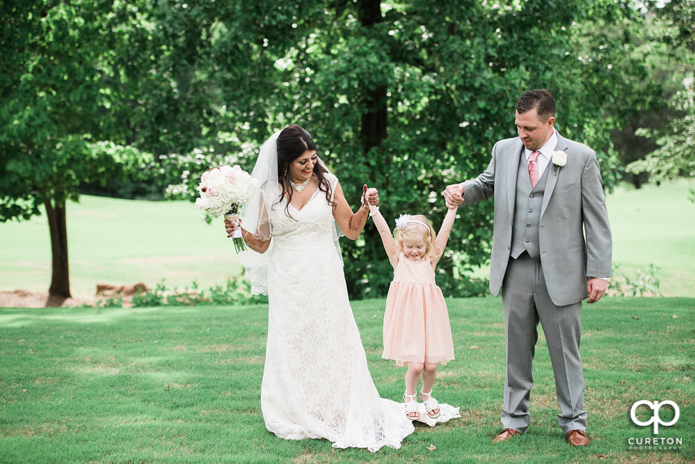 Grooms daughter joins the bride and groom before the wedding.