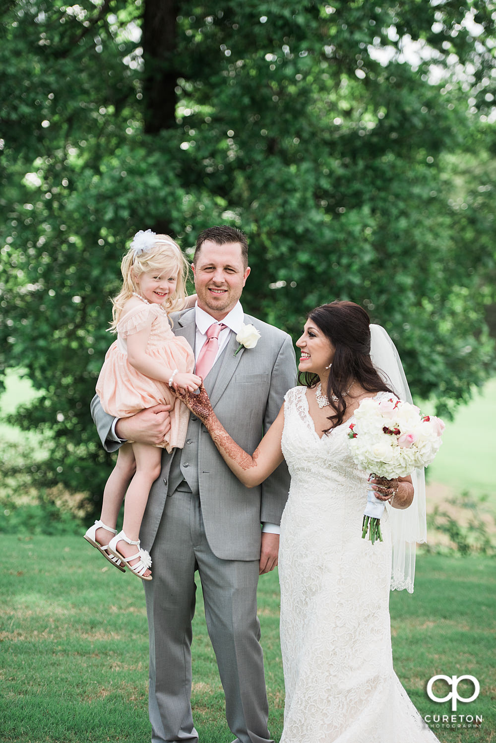 Grooms daughter joins the bride and groom before the wedding.