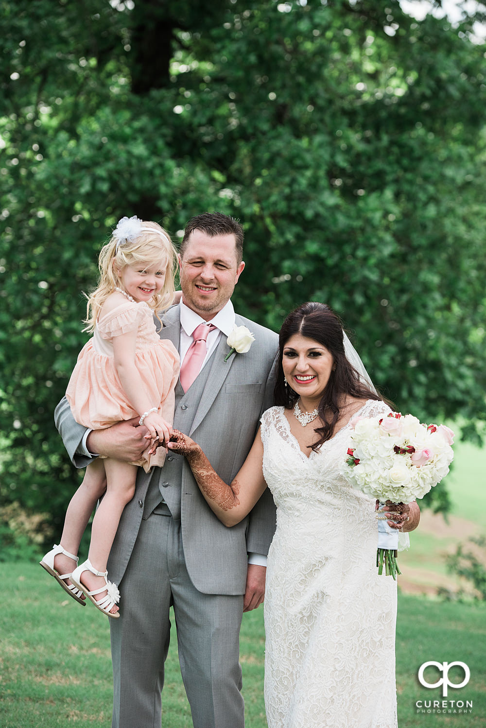 Grooms daughter joins the bride and groom before the wedding.