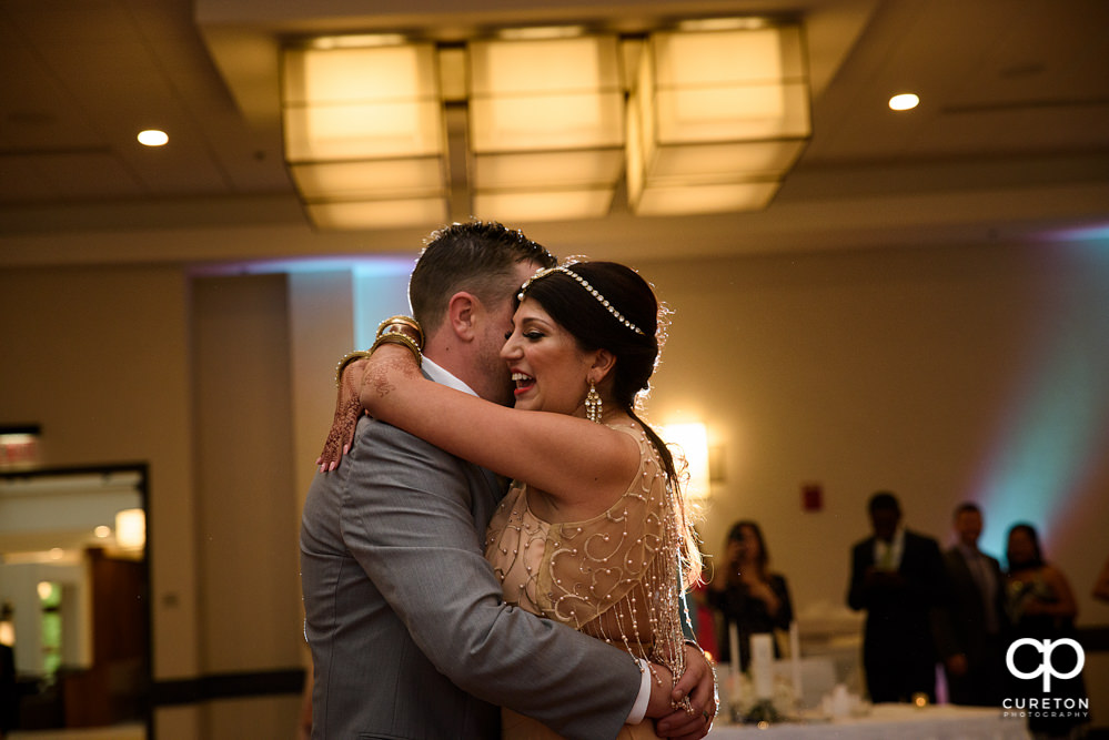 Bride and groom share a first dance at the wedding reception at Embassy Suites in Greenville.