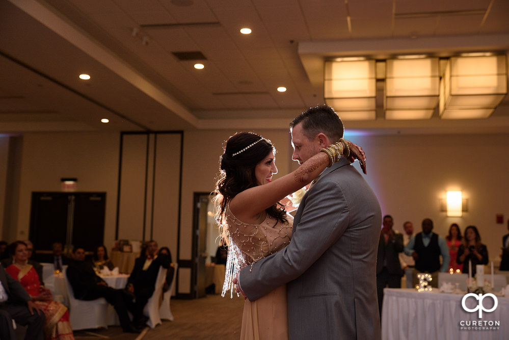 Bride and groom share a first dance at the wedding reception at Embassy Suites in Greenville.