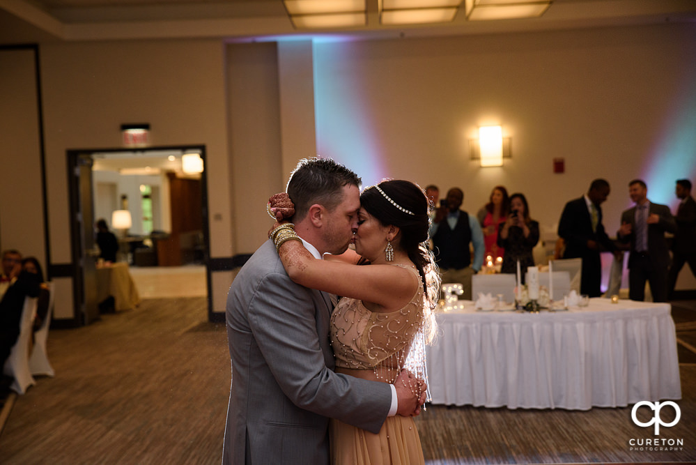 Bride and groom share a first dance at the wedding reception at Embassy Suites in Greenville.