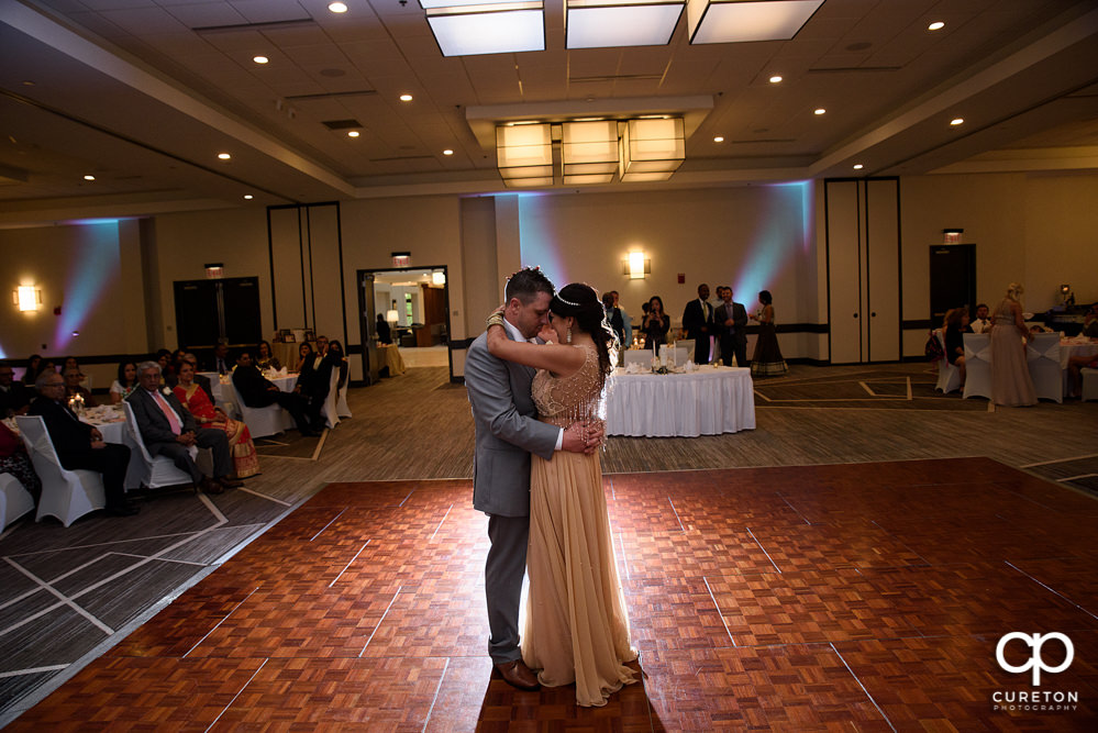 Bride and groom share a first dance at the wedding reception at Embassy Suites in Greenville.