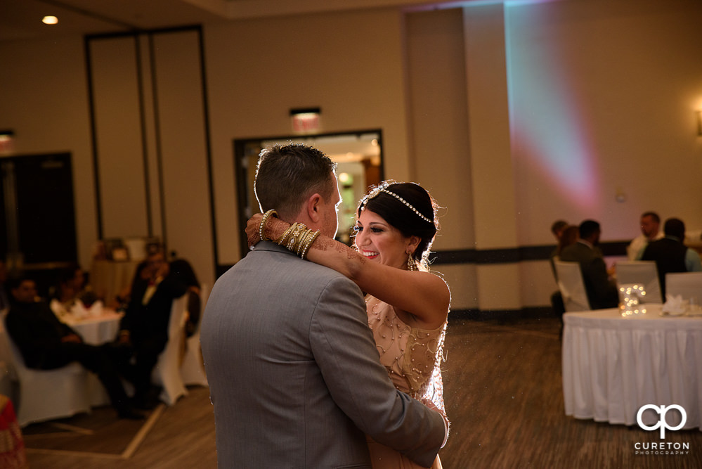 Bride and groom share a first dance at the wedding reception at Embassy Suites in Greenville.