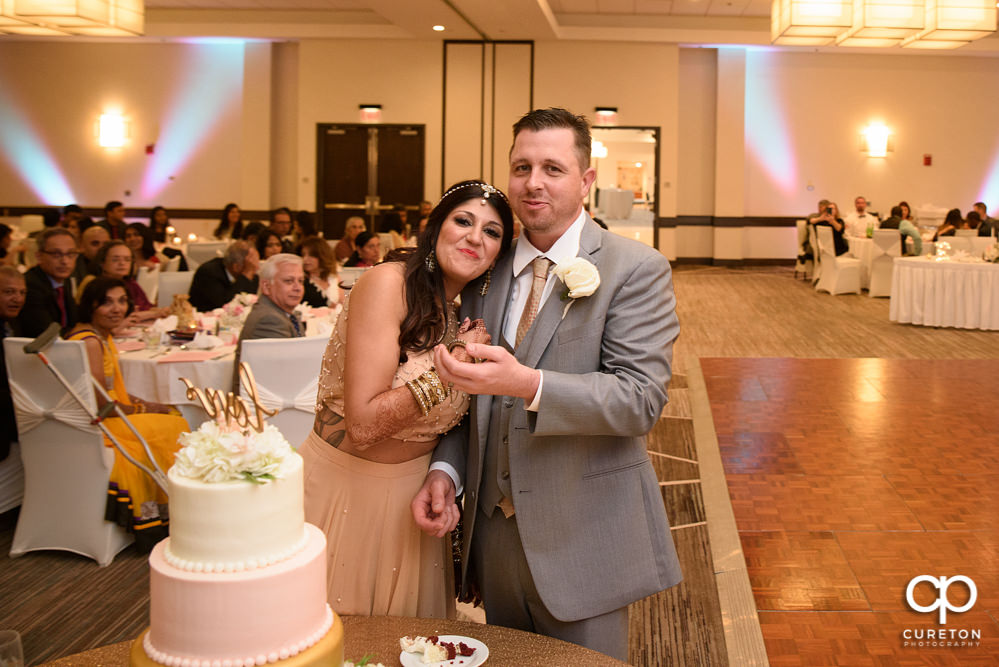 Bride and groom cutting the cake.