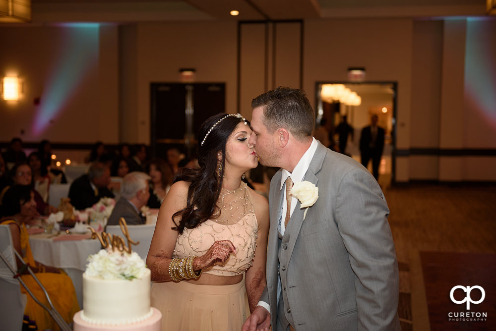 Bride and groom cutting the cake.