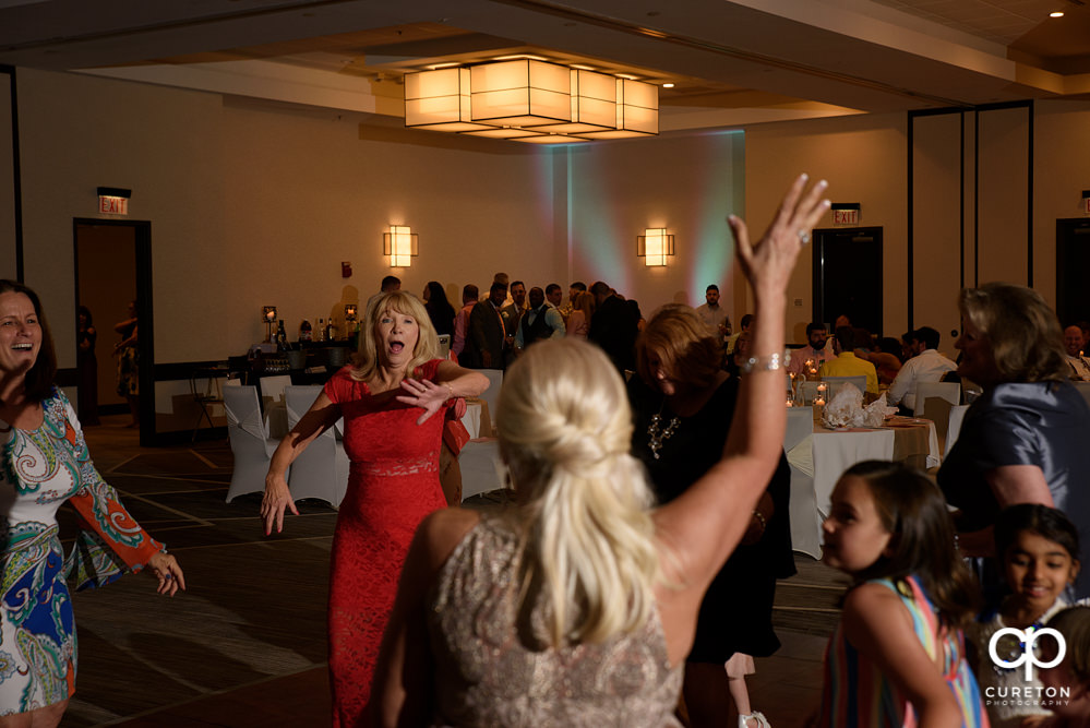 Wedding guests dancing at the reception.