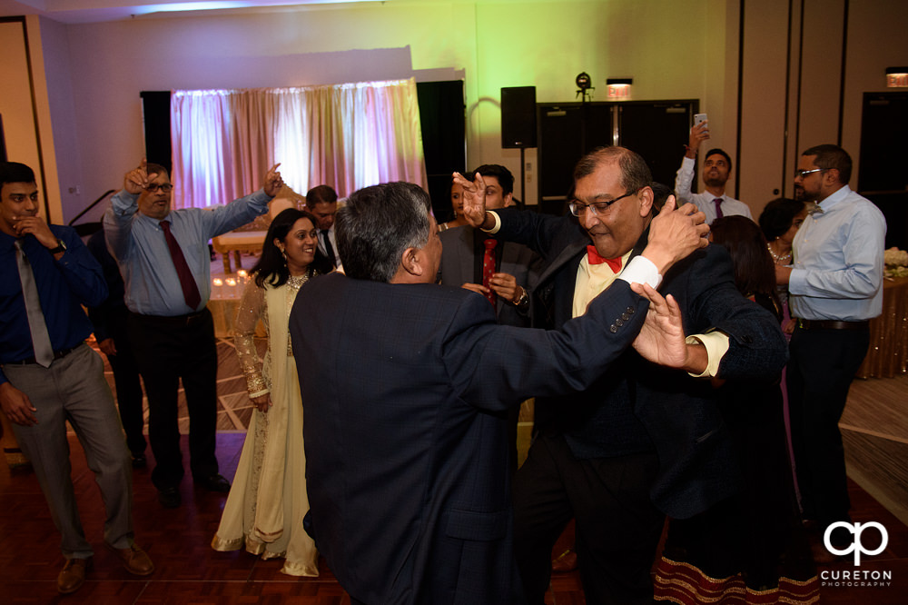 Wedding guests dancing at the reception.