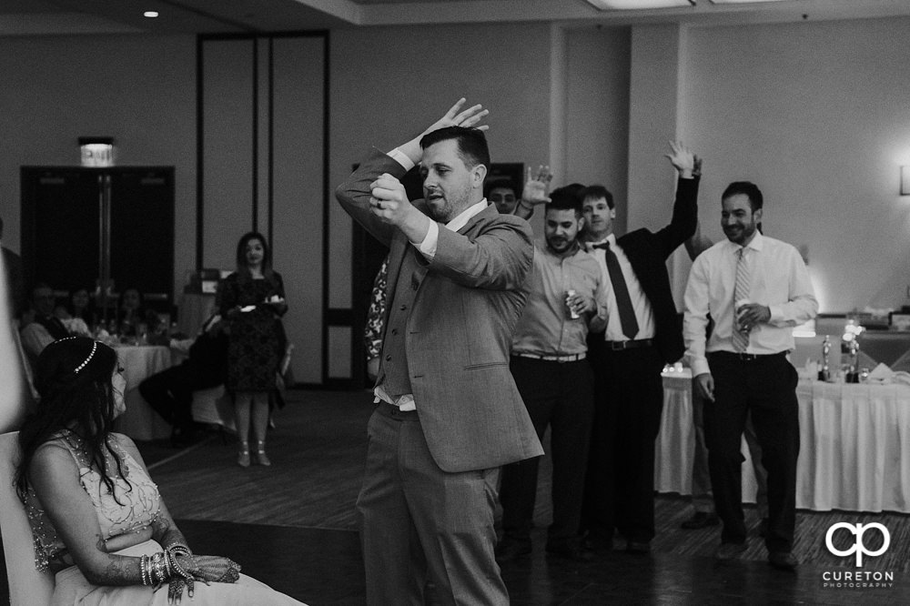 Groom tossing the garter.