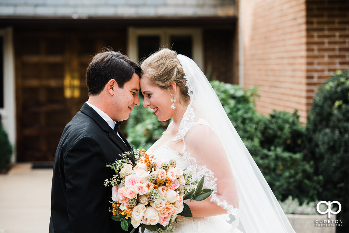 Bride and groom sharing a moment before their wedding reception at Indigo Hall in Spartanburg.