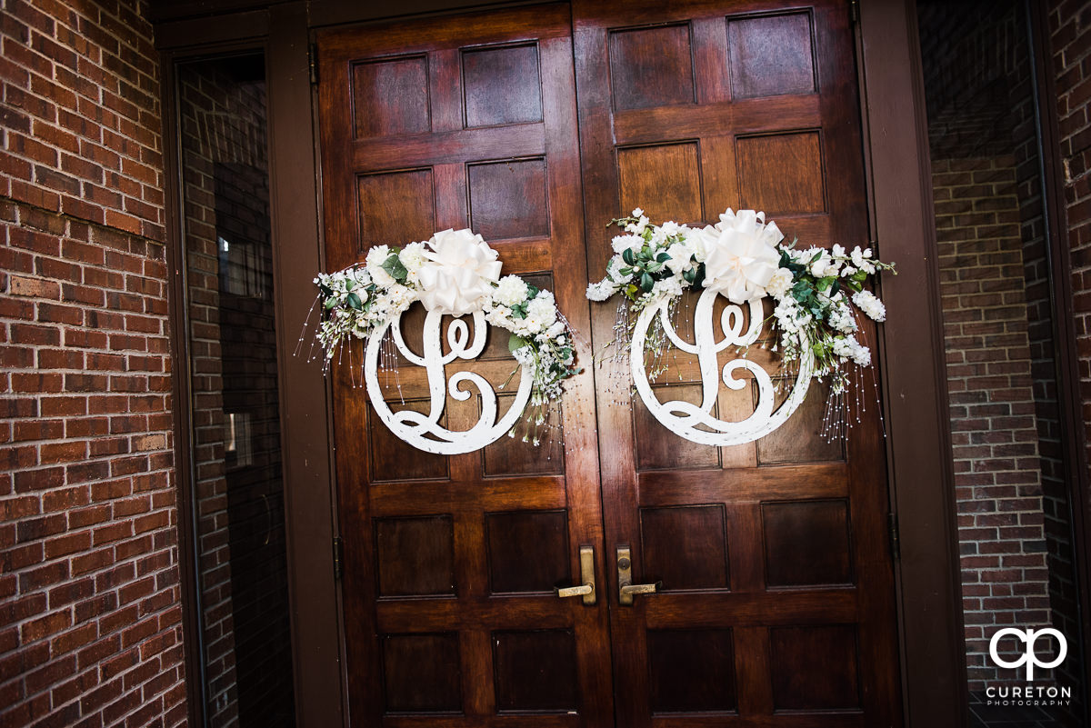Monograms and flowers on the church doors.