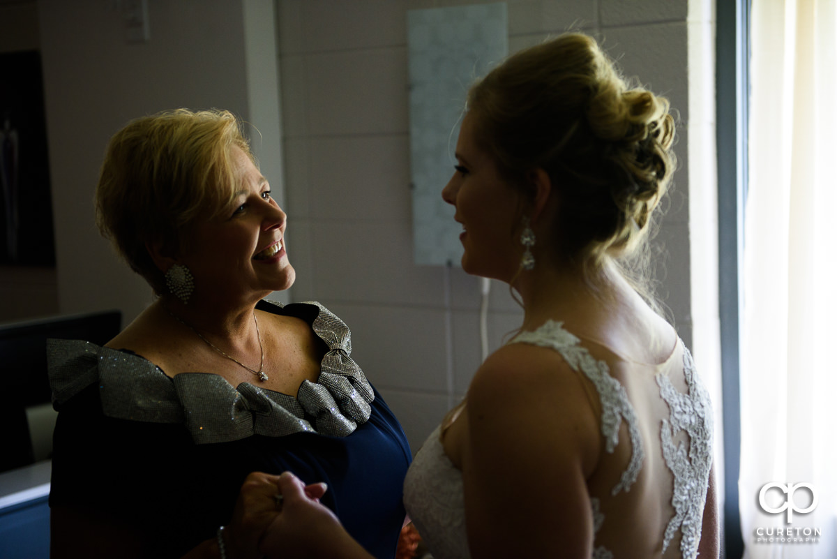 Bride and her mom sharing a moment before the wedding ceremony.