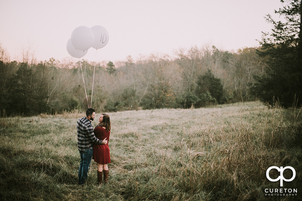 Bride and groom in a field with balloons in Greenville,SC.