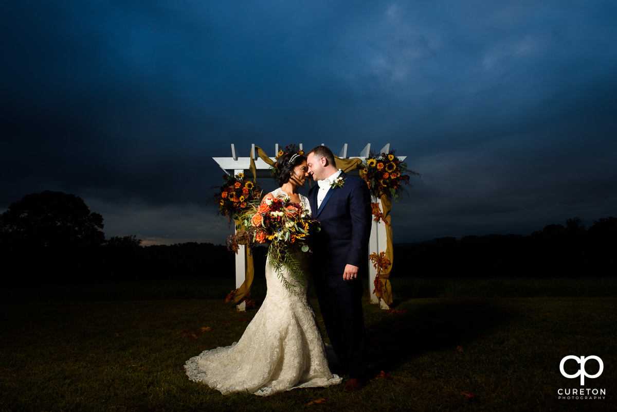 Bride and groom standing in the field after their fall wedding at Lindsey Plantation in Taylors,SC.