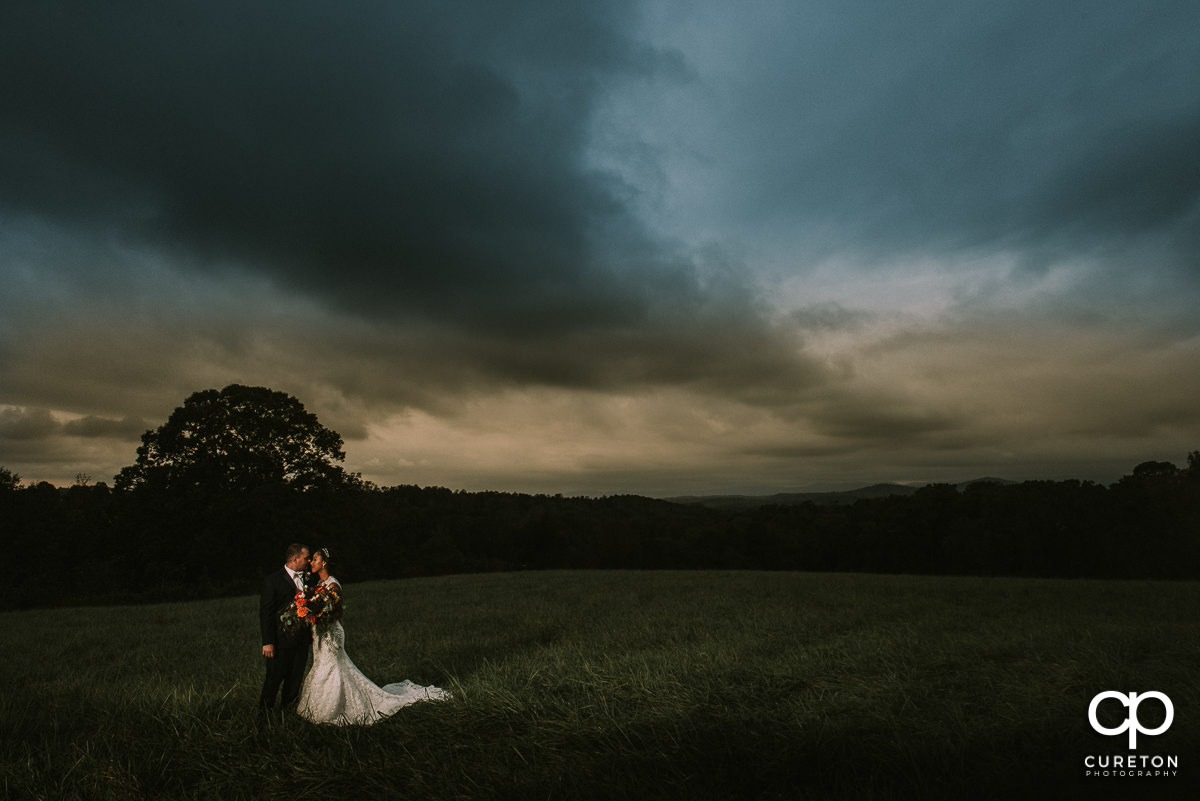 Bride and groom in the field at Lindsey Plantation after their October wedding.