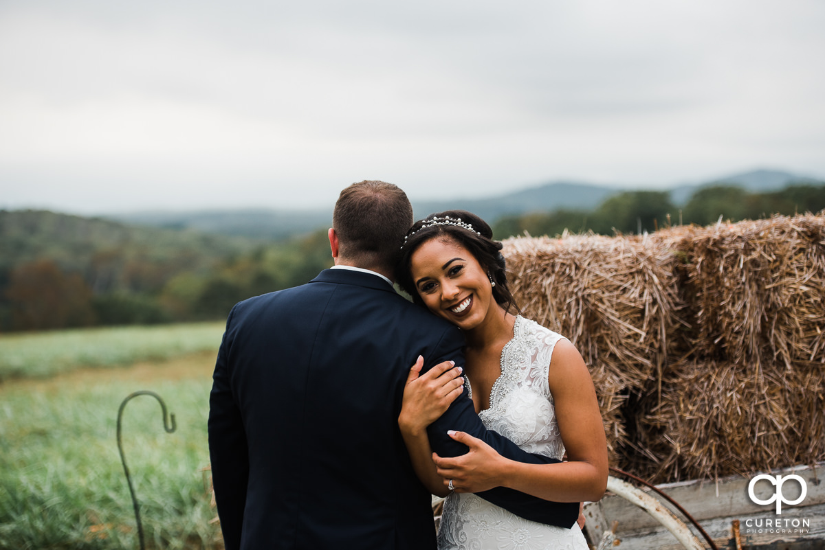 Bride holding her groom's arm.