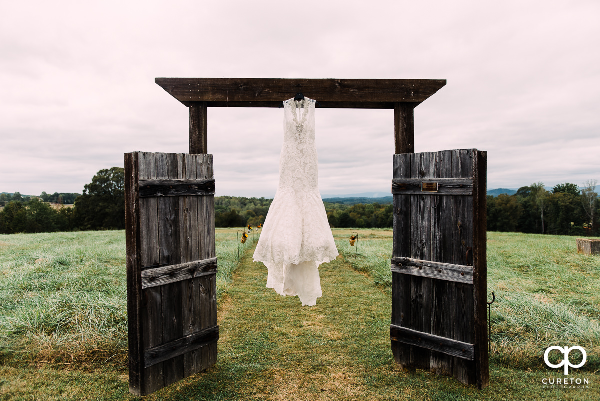 Bride's dress on rustic doors.
