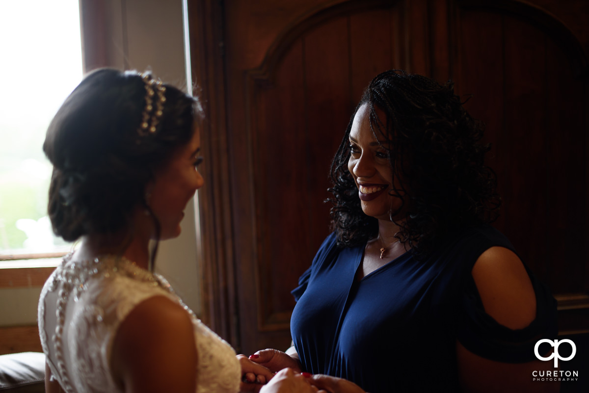 Bride's mom smiling at her.