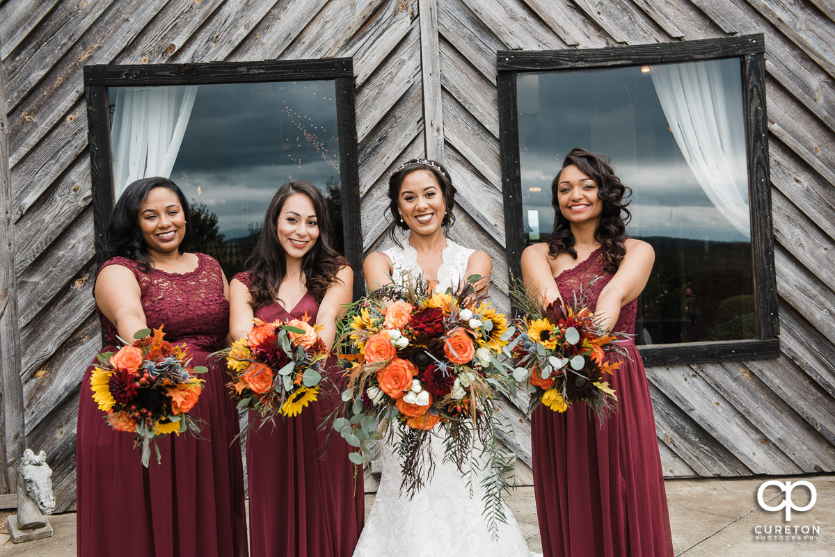 Bride and bridesmaids with amazing fall florals before the wedding.