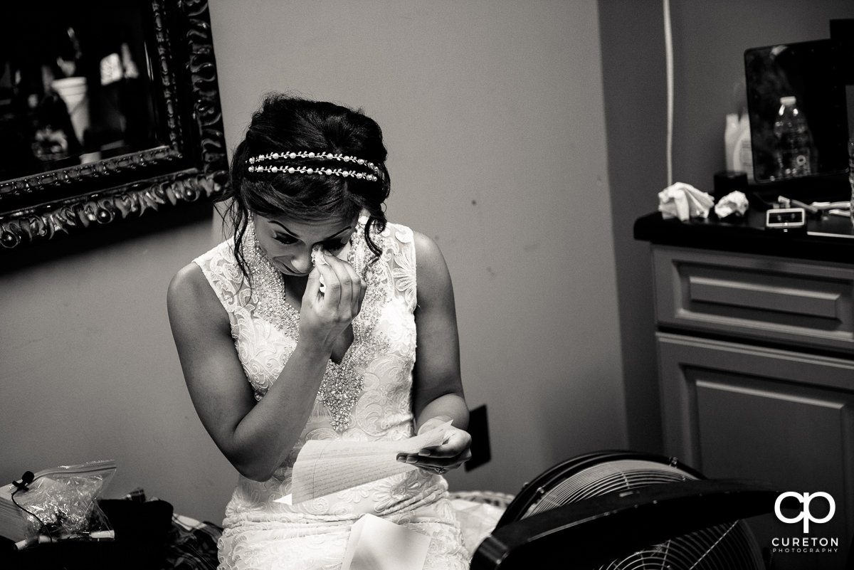 Bride tearing up when she received the groom's wedding gift.