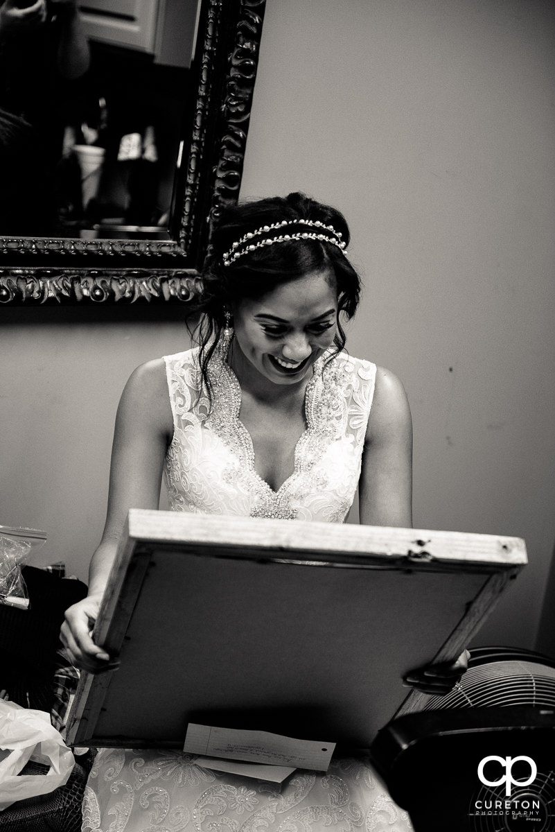 Bride happy looking at her gift.