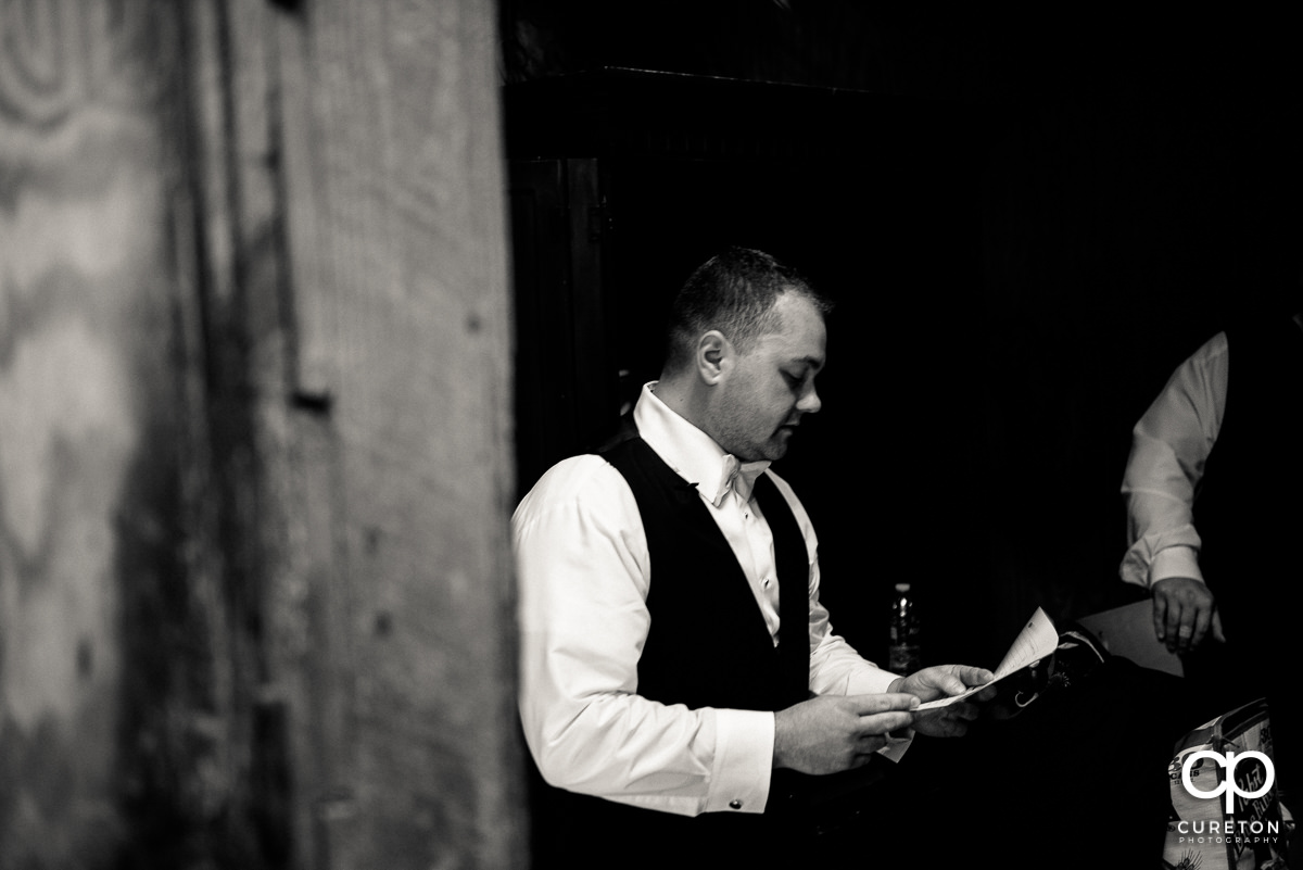 Groom reading a letter from his wife.