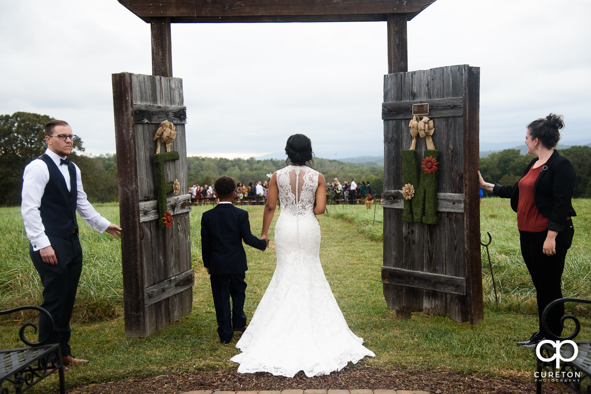 Bride and her son walk down the aisle at Lindsey Plantation.