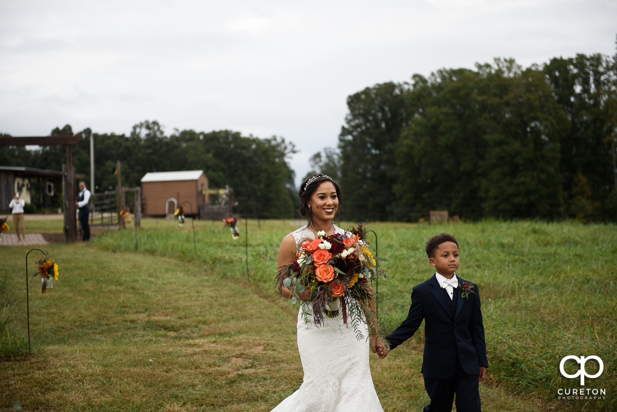 Bride and son walking down the aisle.