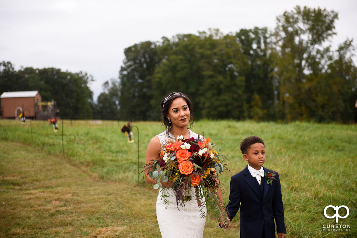 Bride sees her husband as she walks down the aisle.