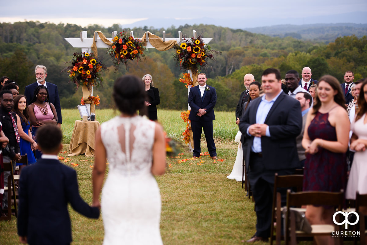 Groom sees his bride walking down the aisle.