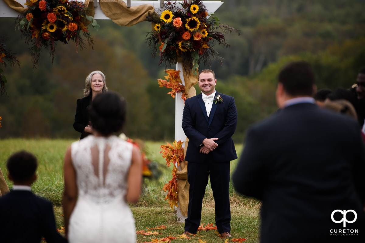 Grooms reaction as he sees his bride walking down the aisle at their fall wedding at Lindsey Plantation in Taylors,SC.
