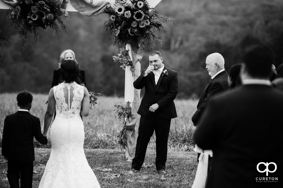 Groom tears up seeing his bride for the first time.