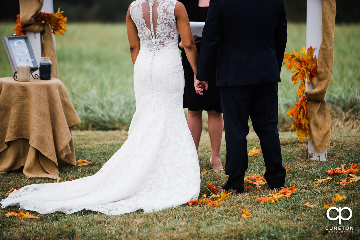 Bride and groom holding hands.