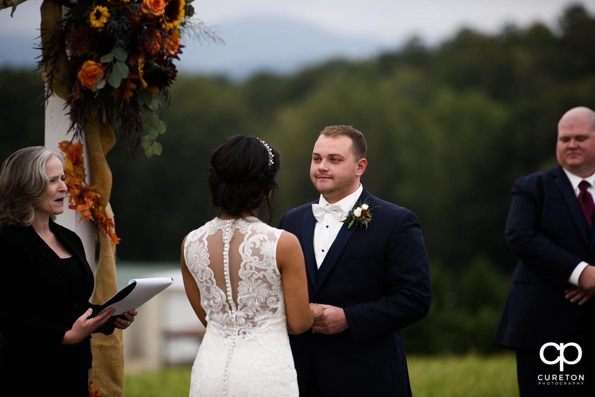 Groom looking at his bride during the wedding ceremony.
