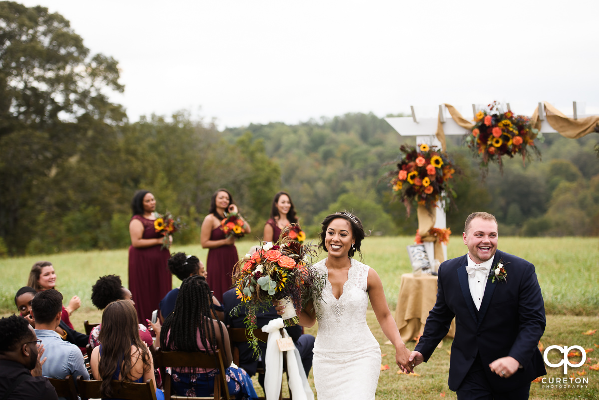 The couple walking back up the aisle.