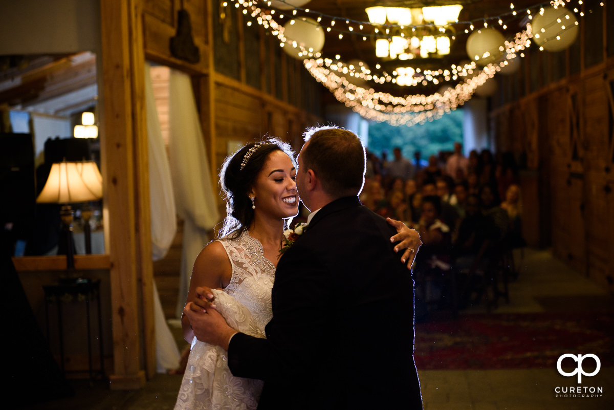 Bride and groom sharing their first dance at the wedding reception.