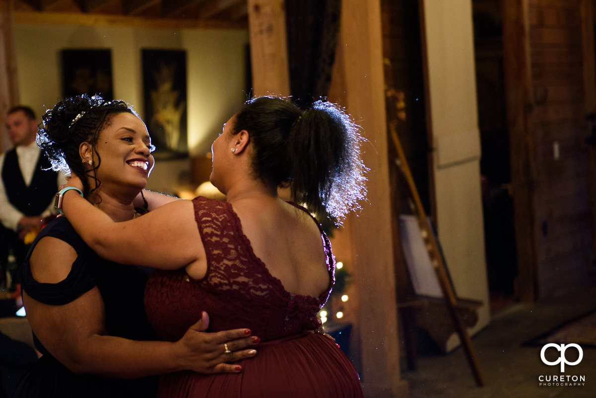 Bride's mother and sister dancing.