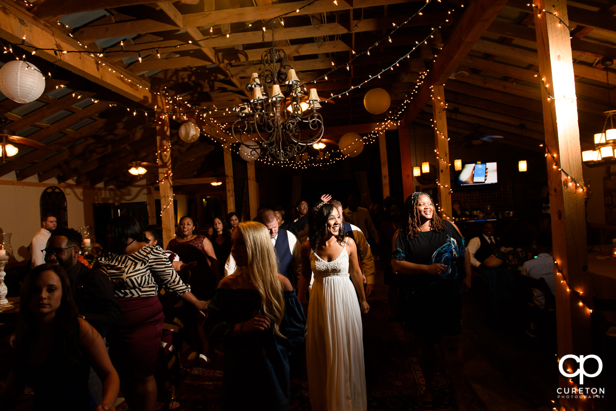 Wedding guests pack the dance floor at the reception.