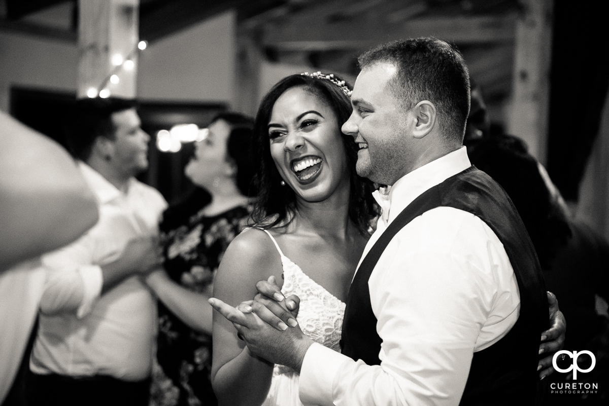 Bride and groom sharing a slow dance.