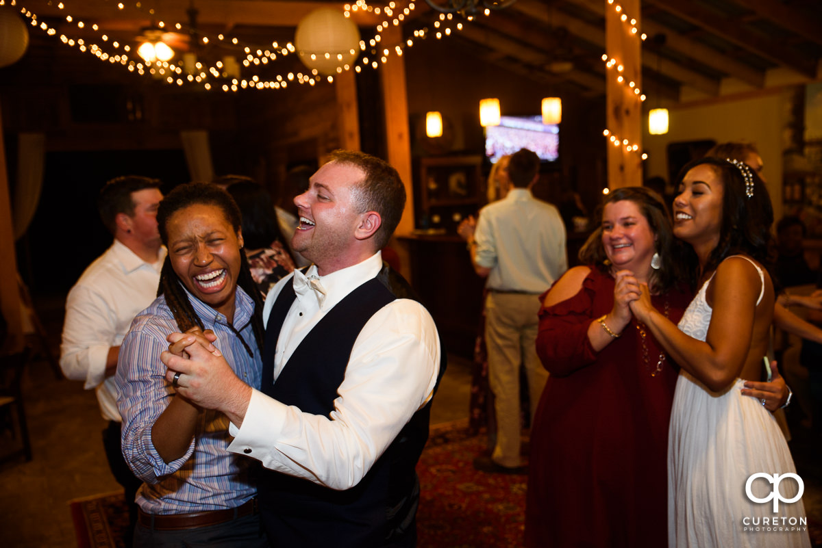 Groom dancing with a friend.