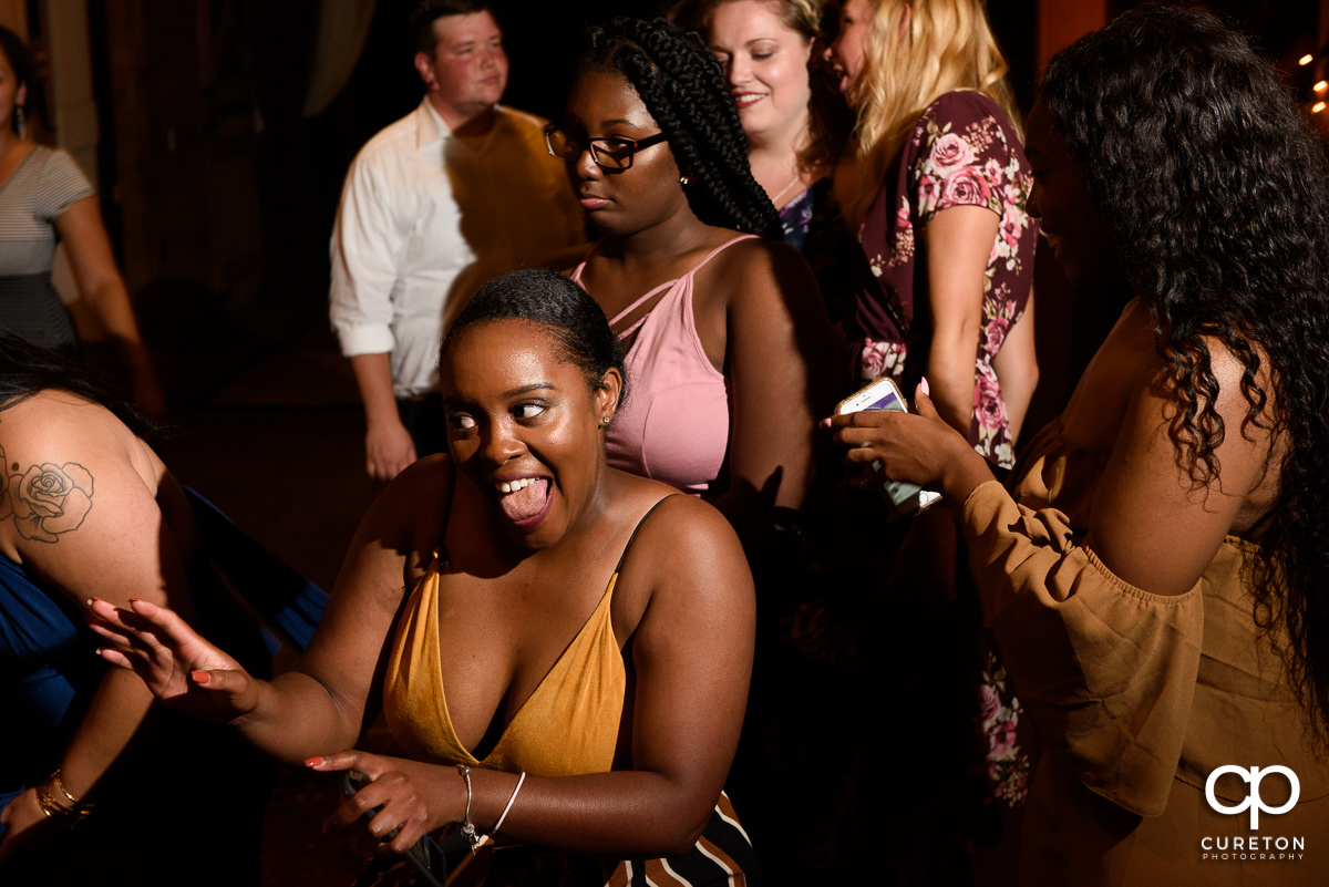 Guest dancing and smiling at the reception.