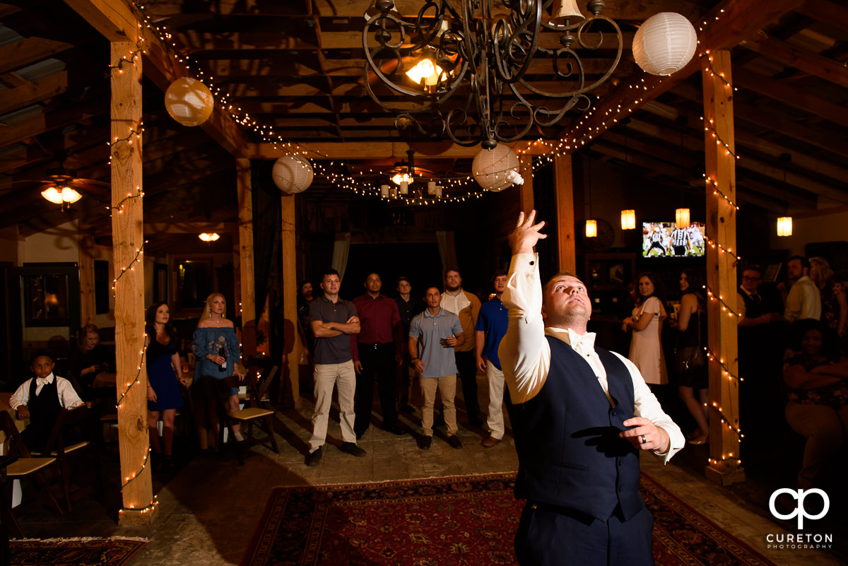 Groom tossing the garter.