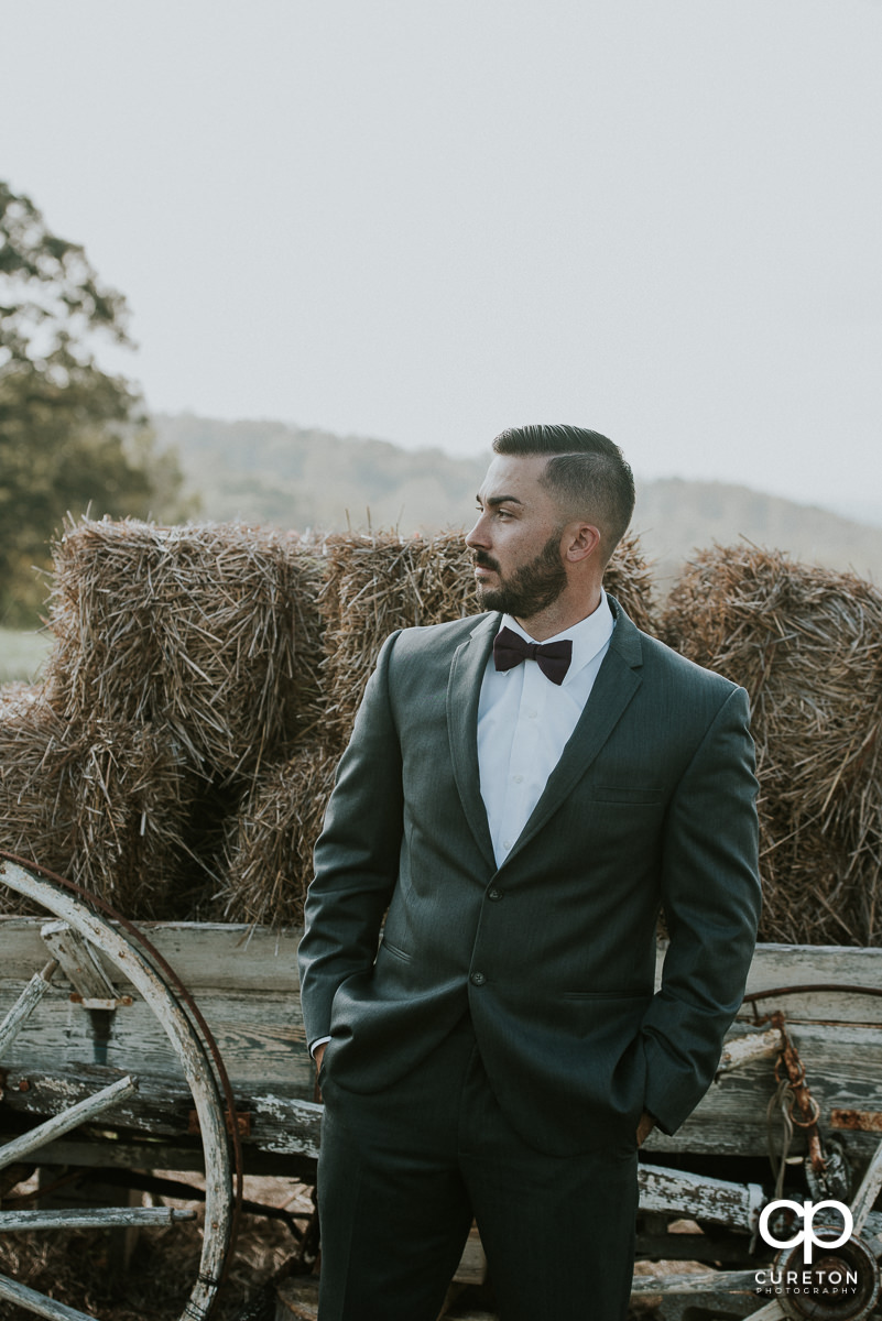 Groom in the field before his Lindsey Plantation rustic wedding.