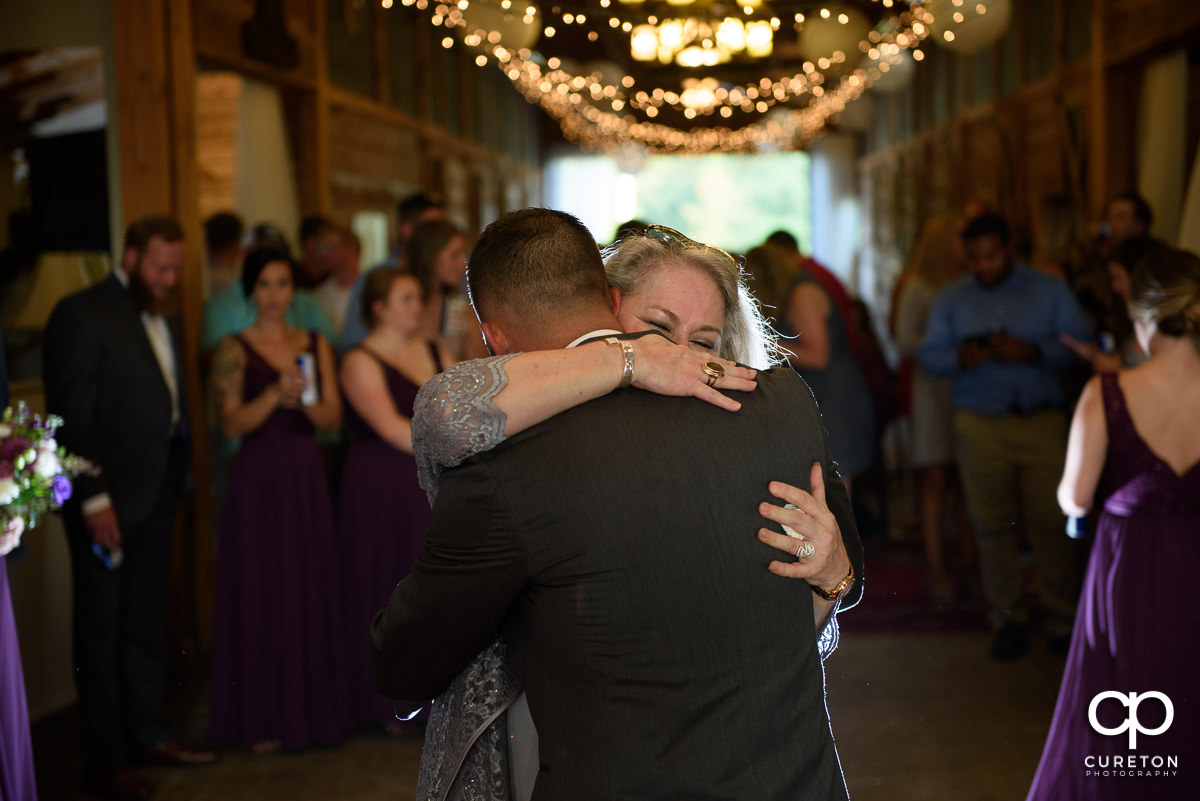 Mom hugging her son, the groom.