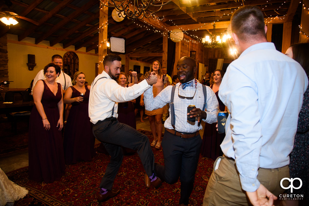 Groom dancing with a friend at the reception.