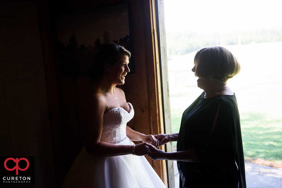 Bride and her mother sharing a moment before the wedding.