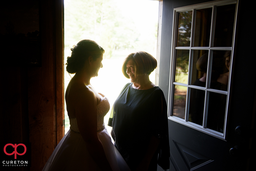 Bride and her mother sharing a moment before the wedding.