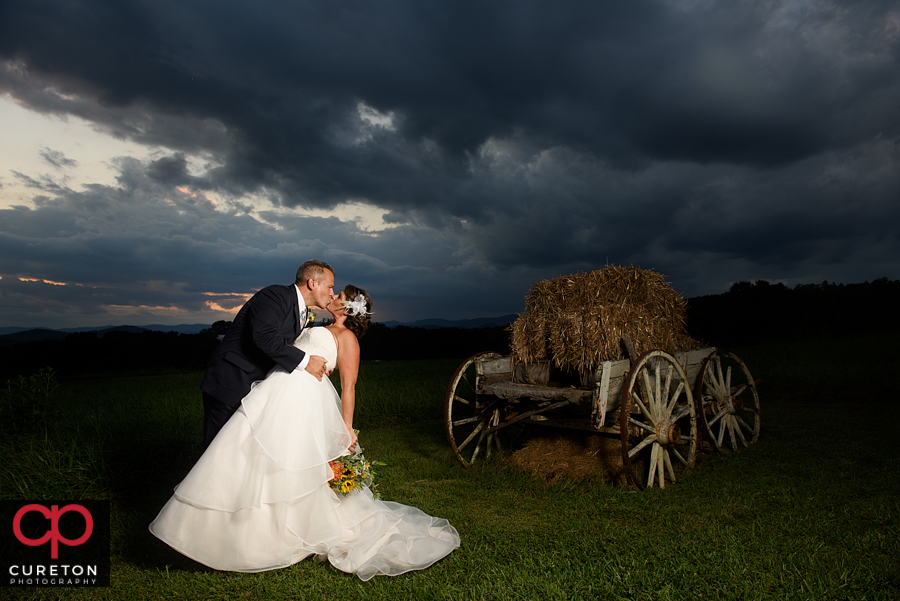 Married couple kissing at sunset.